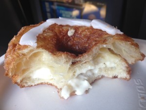 The inside of the cronut, with its flaky layers and cream filling.